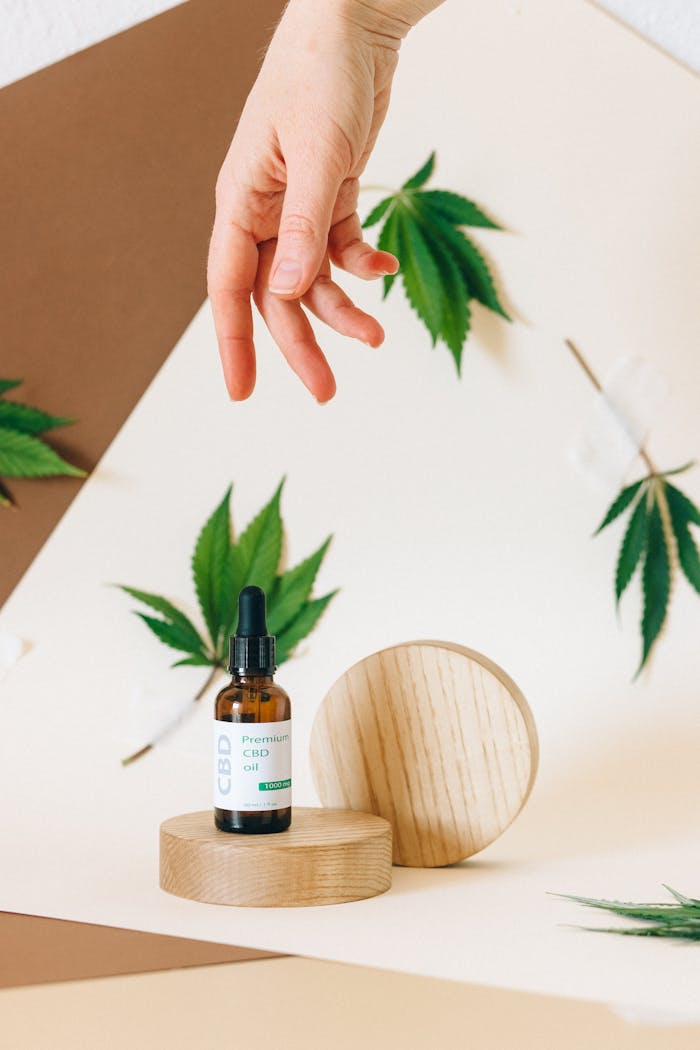 Stylish CBD oil product shot with cannabis leaves, ideal for wellness themes.
